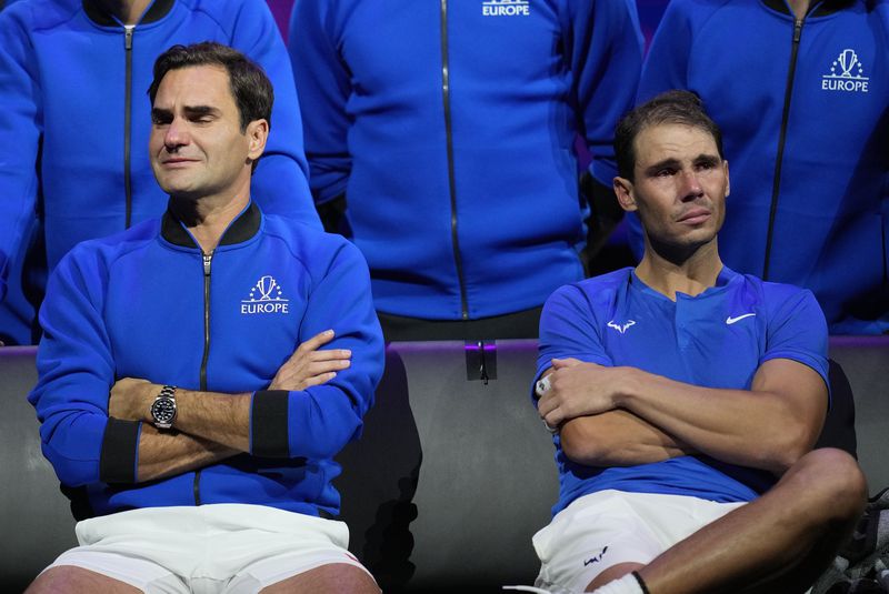 FILE - An emotional Roger Federer, left, of Team Europe, sits alongside his playing partner, Rafael Nadal, after their Laver Cup doubles match against Team World's Jack Sock and Frances Tiafoe at the O2 arena in London, Friday, Sept. 23, 2022. (AP Photo/Kin Cheung, File)