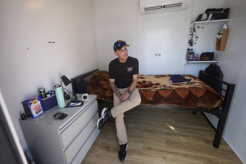 Steven Burcell is interviewed in his room at the Five Keys' Mission Cabins transitional housing location in San Francisco, Monday, Aug. 26, 2024. (AP Photo/Jeff Chiu)