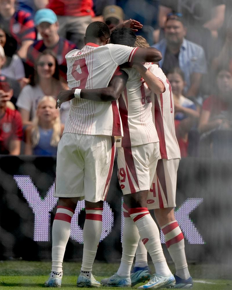 Canadian players celebrate after a goal during the first half of an international friendly soccer game against United States, Saturday, Sept. 7, 2024, in Kansas City, Mo. (AP Photo/Charlie Riedel)