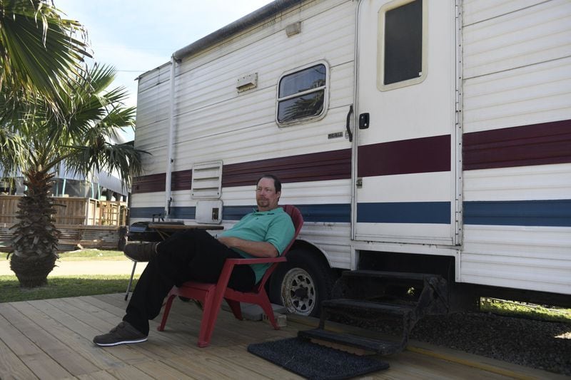 Kenny Gardiner sits in front of his RV, Friday, Feb. 28, 2020, in Port Aransas, Texas. Gardiner says that he is having a difficult time finding work after his conviction was overturned. ANNIE RICE / FOR THE AJC