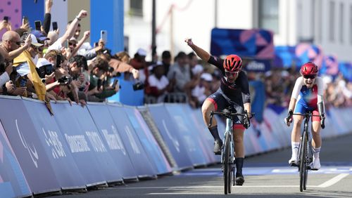 Britain's Sarah Storey, left, celebrates as she wins the gold medal in the women's C4-5 road race during the 2024 Paralympics, Friday, Sept. 6, 2024, in Clichy-sous-Bois, France. (AP Photo/Aurelien Morissard)