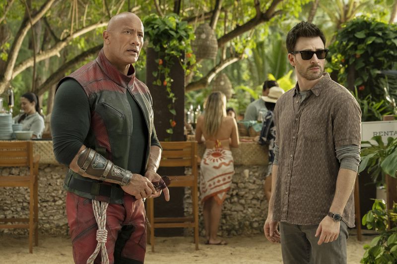 This image released by Amazon Prime shows Dwayne Johnson, left, and Chris Evans in a scene from "Red One." (Amazon Prime via AP)