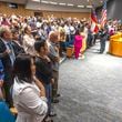 Some 150 participants and their friends and family stand for the Presentation of Colors during a naturalization ceremony for new citizens at the Gwinnett Justice and Administration Complex in Lawrenceville on Tuesday, July 2, 2024.  (Steve Schaefer / AJC)