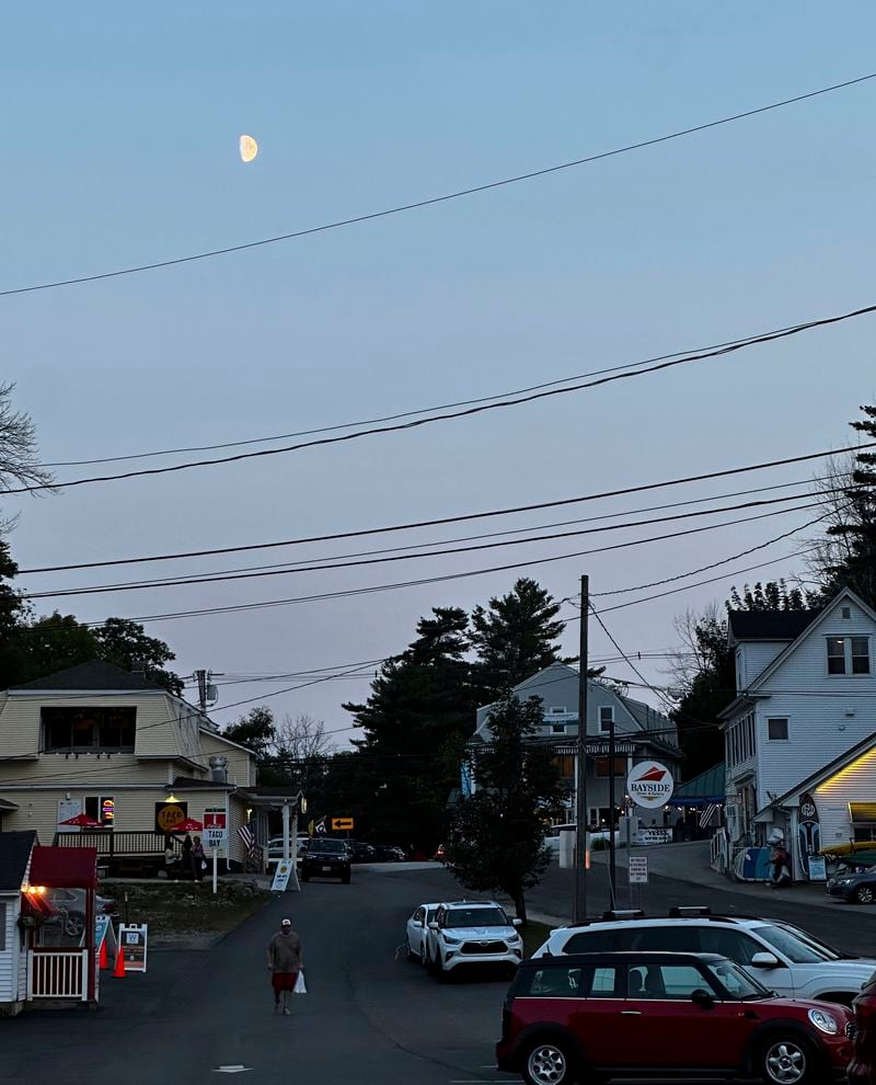 The moon rises over Alton, New Hampshire as Canada and northern U.S. cities experience moderate solar storms that could spark aurora borealis, Thursday, Sept. 12, 2024. (AP Photo/Caleb Jones)