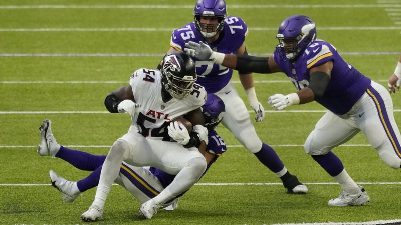 Atlanta Falcons linebacker Foye Oluokun (54) is brought down with the ball after a turnover against the Minnesota Vikings during the first half Sunday, Oct. 18, 2020, in Minneapolis. It was Oluokun's first interception of his career - and the third by the Falcons in the first half. (Jim Mone/AP)