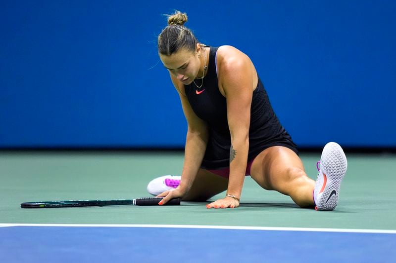 Aryna Sabalenka, of Belarus, does a split after a return against Zheng Qinwen, of China, during the quarterfinals of the U.S. Open tennis championships, Tuesday, Sept. 3, 2024, in New York. (AP Photo/Eduardo Munoz Alvarez)