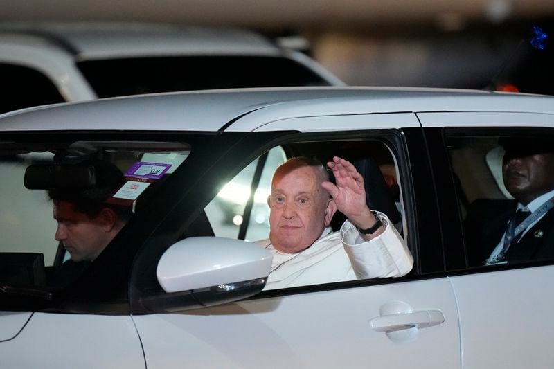 Pope Francis waves to the gathering as he leaves Jackson's International Airport in Port Moresby, Papua New Guinea, Friday, Sept. 6, 2024. (AP Photo/Mark Baker)