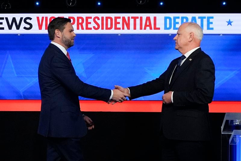 Republican U.S. Sen. JD Vance of Ohio (left) and Democratic Minnesota Gov. Tim Walz shake hands before the vice presidential debate on Tuesday.