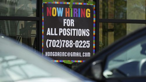 A hiring sign is displayed at a restaurant in Mount Prospect, Ill., Tuesday, Aug. 27, 2024. (AP Photo/Nam Y. Huh)