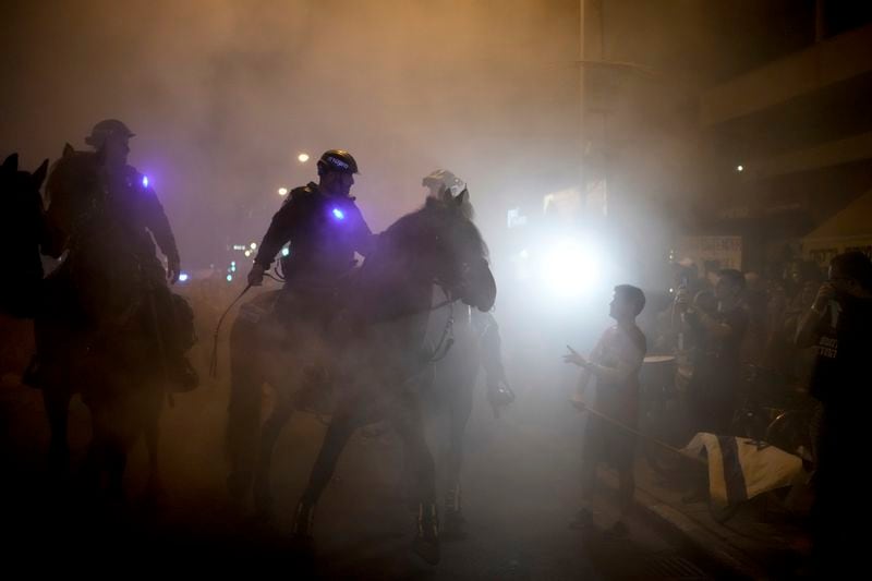 Israeli mounted police officers disperse demonstrators blocking a road during a protest against Israeli Prime Minister Benjamin Netanyahu's government and call for the release of hostages held in the Gaza Strip by the Hamas militant group, in Tel Aviv, Israel, Saturday, June 22, 2024. (AP Photo/Leo Correa)