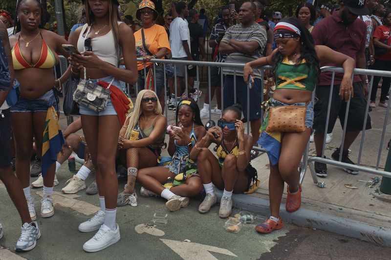 Revelers gather during the West Indian Day Parade on Monday, Sept. 2, 2024, in the Brooklyn borough of New York. (AP Photo/Andres Kudacki)