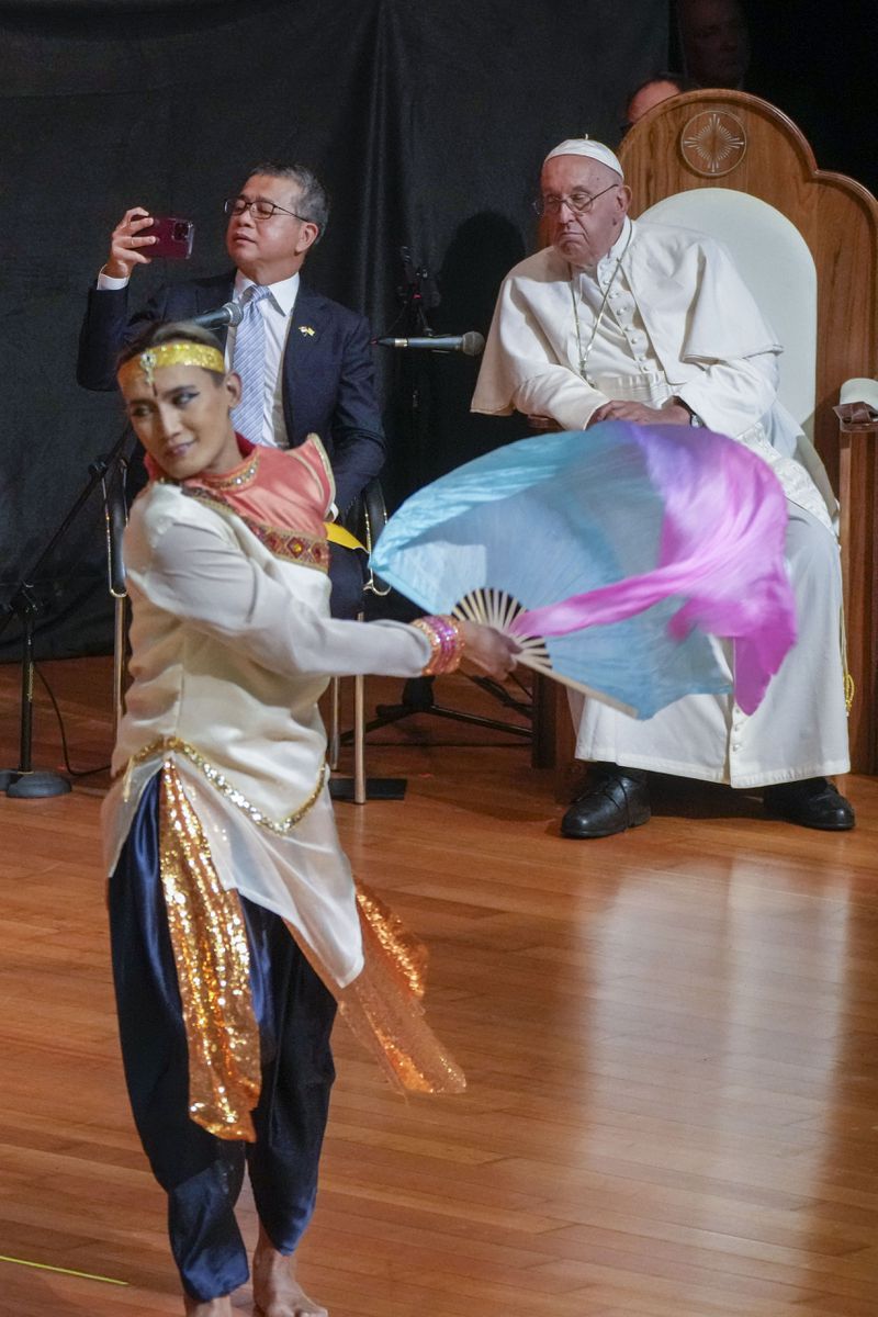 Pope Francis and Singapore's Minister of Culture Edwin Tong, left, attends an intereligious meeting with young people at the Catholic Junior College in Singapore, Friday, Sept. 13, 2024. Pope Francis is wrapping up his visit to Singapore by praising its tradition of interfaith harmony. (AP Photo/Gregorio Borgia)