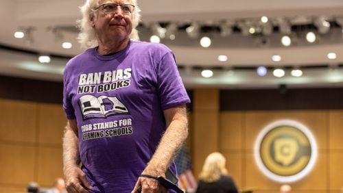 A supporter of Cobb County teacher Katie Rinderle walks out of a hearing at the Cobb County Board of Education in Marietta on Thursday, August 10, 2023. Rinderle was fired by the school board in a partisan vote for reading “My Shadow is Purple,” a book about gender identity, to fifth graders. (Arvin Temkar / arvin.temkar@ajc.com)