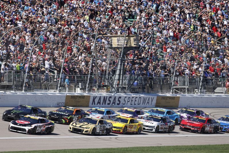 Drivers head toward Turn 1 during the start of a NASCAR Cup Series auto race at Kansas Speedway in Kansas City, Kan., Sunday, Sept. 29, 2024. (AP Photo/Colin E. Braley)