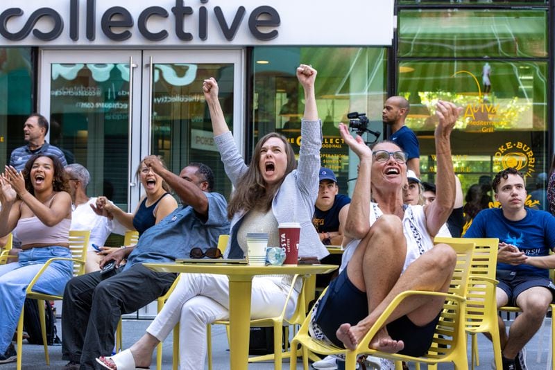 Fans react while watching a Wimbledon quarterfinal match watch party for Christopher Eubanks hosted by Georgia Tech at Coda Courtyard in Atlanta on Wednesday, July 12, 2023. Eubanks, from Westlake High and Georgia Tech,  lost a five-set match to Daniil Medvedev. (Arvin Temkar / arvin.temkar@ajc.com)