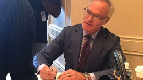 Scott Pelley signing his memoir "Truth Worth Telling" before an Atlanta Press Club newsmakers luncheon May 23, 2019.