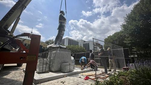 A large bronze statue of the late civil rights leader and politician Congressman John Lewis is installed where a monument to the Confederacy once stood on Friday, Aug. 16, 2024, in Decatur, Ga. (AP Photo/Ron Harris)