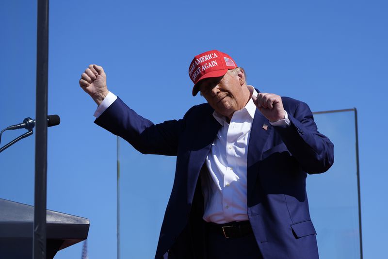 Republican presidential nominee former President Donald Trump dances after speaking at a campaign rally at Wilmington International Airport, Saturday, Sept. 21, 2024, in Wilmington, N.C. (AP Photo/Alex Brandon)