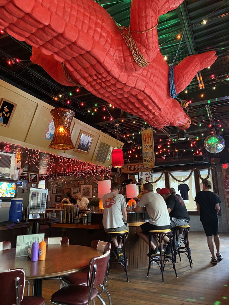 A 20-foot red alligator dangling from the ceiling contributes to the eclectic decor at Gene's. (Ligaya Figueras/lfigueras@ajc.com)