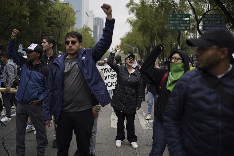 Demonstrators protest outside the Senate against the judicial reform bill in Mexico City, Thursday, Sept. 5, 2024, the day after Congress passed legislation that would require all judges to stand for election. (AP Photo/Felix Marquez)